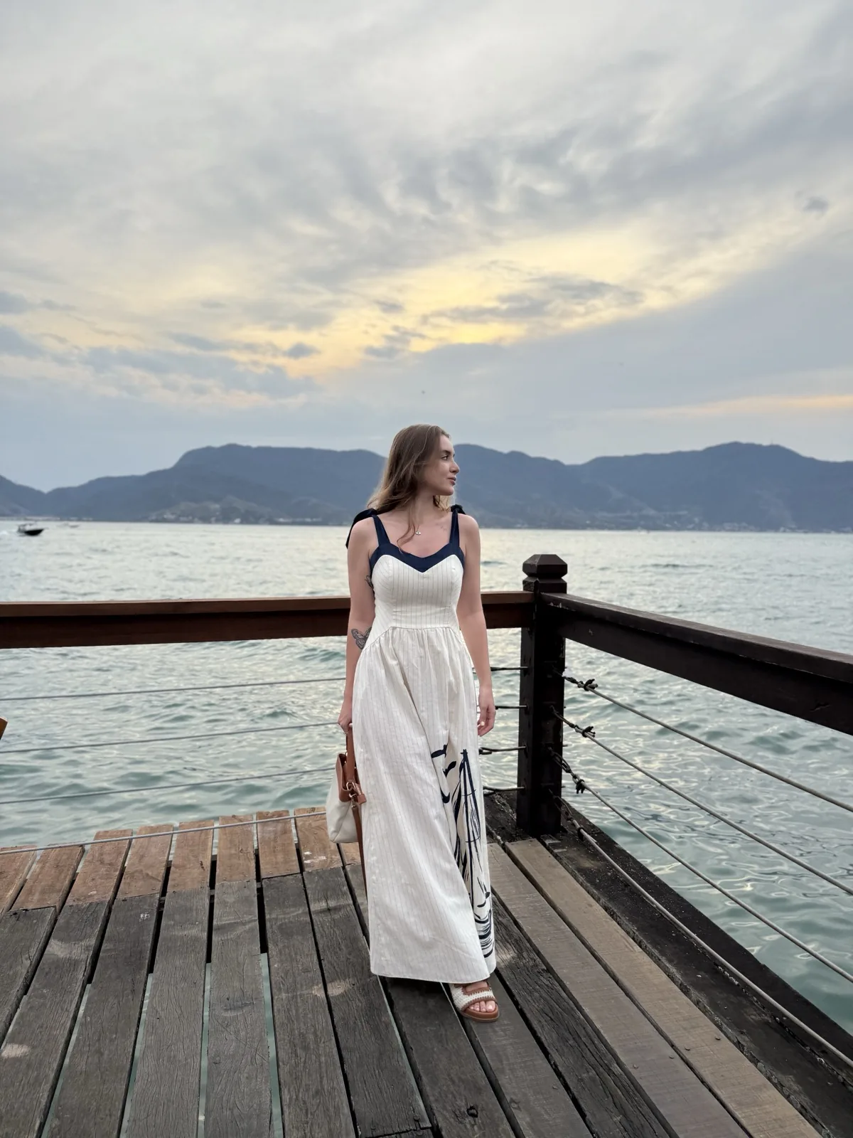 Look Sal da Terra — vestido longo branco em píer à beira-mar